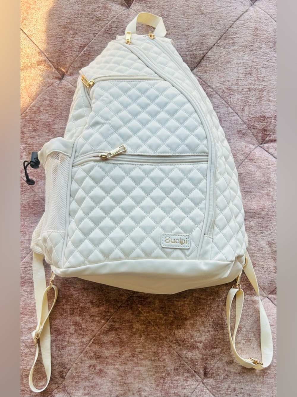 Sucipi Womens Pickleball White Backpack with gold accents.
